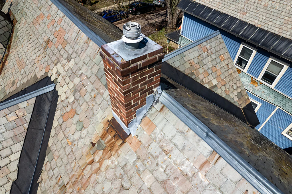 Roof Cricket Installation Behind Chimneys to Prevent Water Pooling